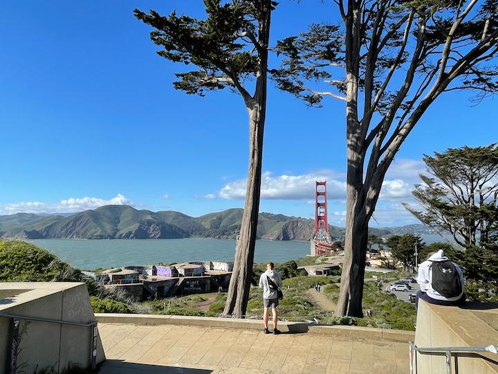 Views of the Golden Gate Bridge from the Golden Gate Overlook with two visitors taking in the view.