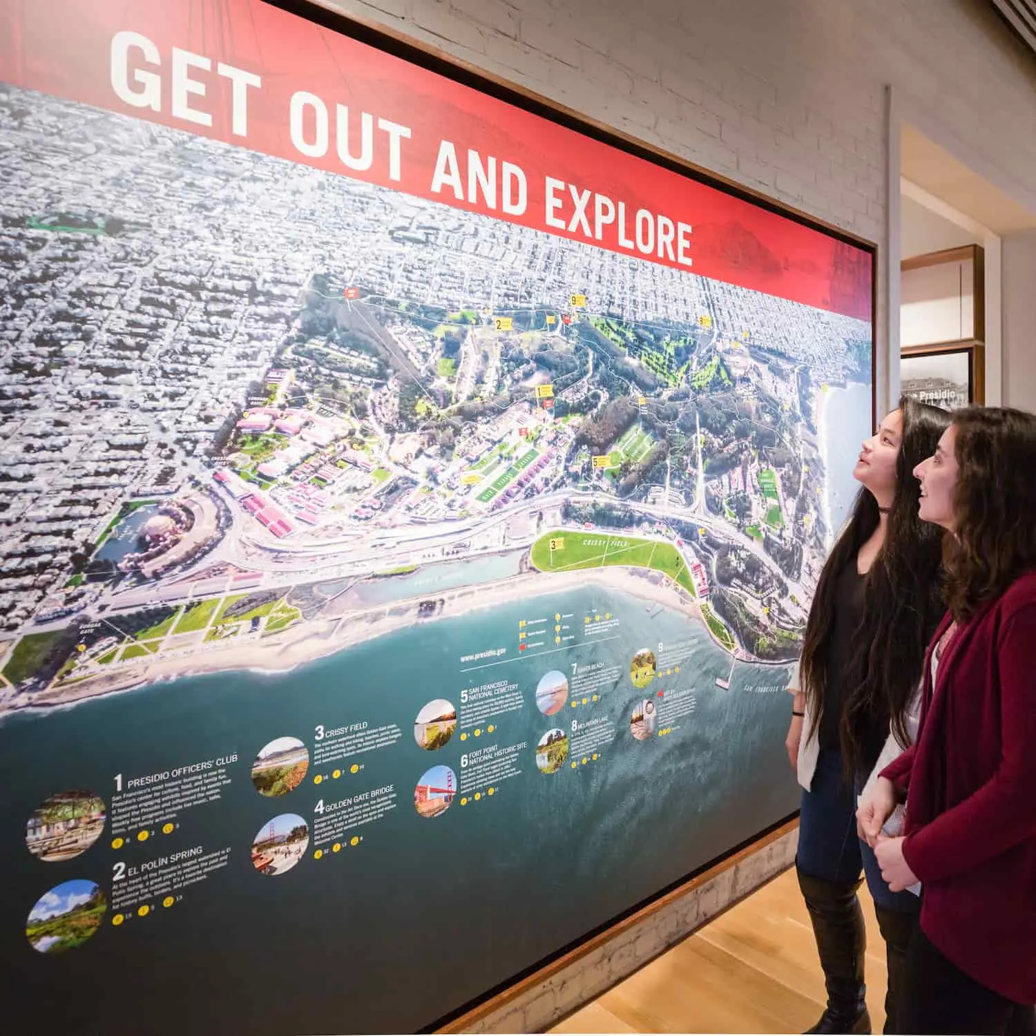 Two women looking at a large map of the Presidio. Photo by Charity Vargas.