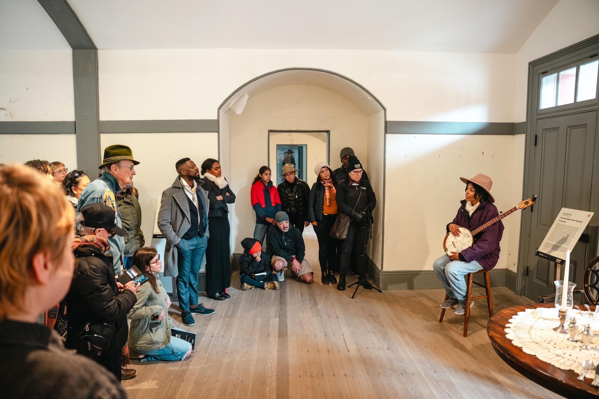 crowd gathered to listen to an actor at Fort Point for the Black Gold event