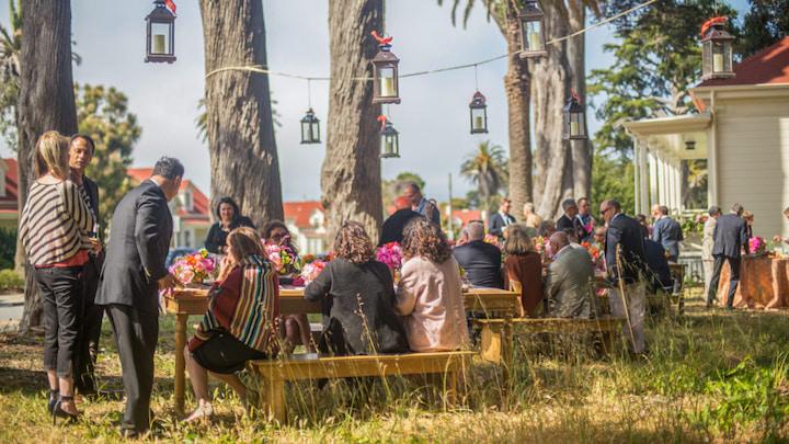 A group gathers outdoors for a small event at the Funston House.