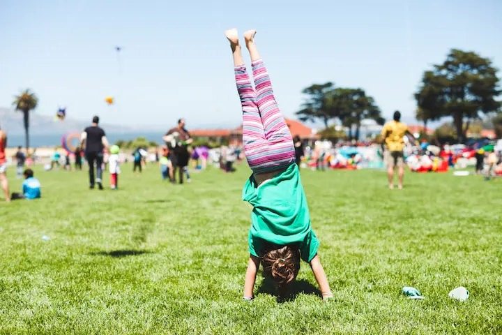 Girl doing a handstand on the Main Parade Lawn in the Presidio of San Francisco.