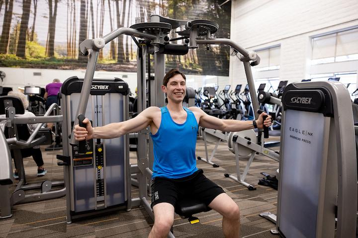 A man working out on a machine on the Presidio Y fitness floor. Photo courtesy of the Presidio Y.