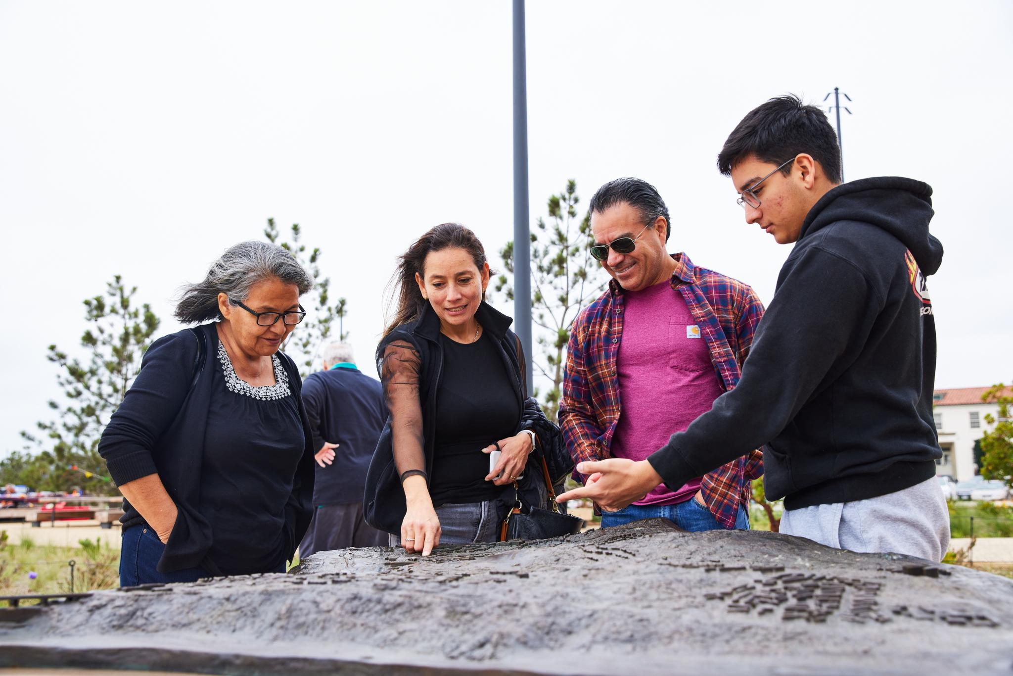 4 adults looking at the 3D map of the Presidio of San Francisco