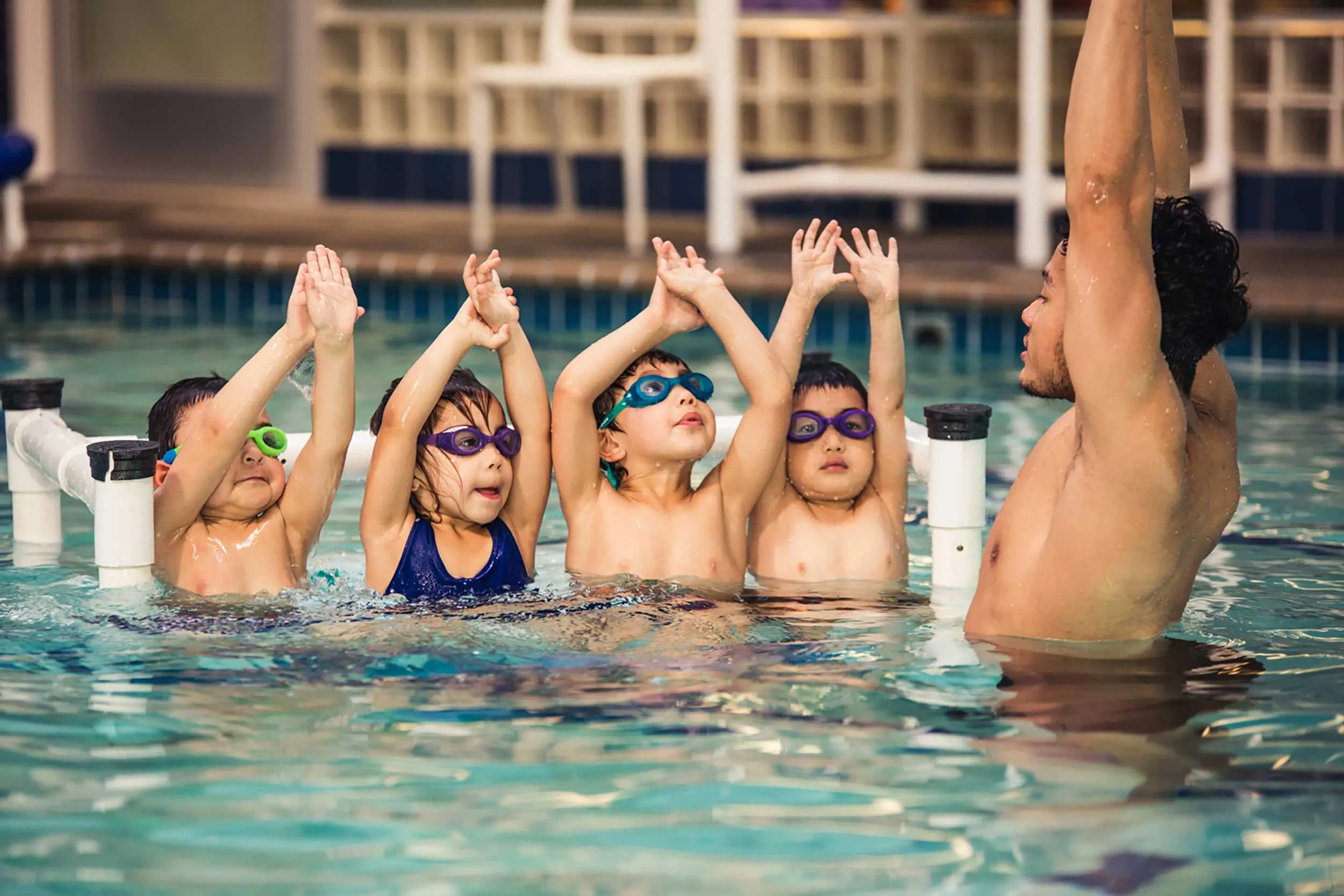 A teacher with four children in the pool at La Petite Baleen Swim School in the Presidio. Photo courtesy of La Petite Baleen.