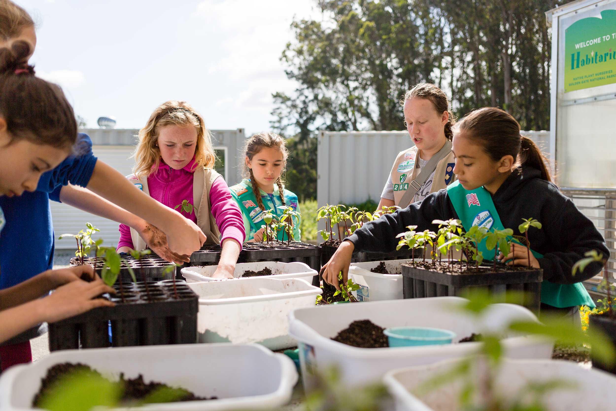 Adults and children volunteering at Presidio Nursery. Photo by Charity Vargas.