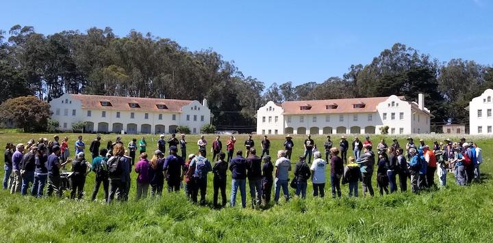 A large group of volunteers gathers at Fort Winfield Scott.