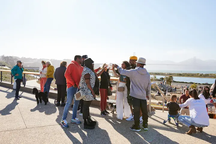 People having a toast at Crossroads Overlook at Presidio Tunnel Tops.