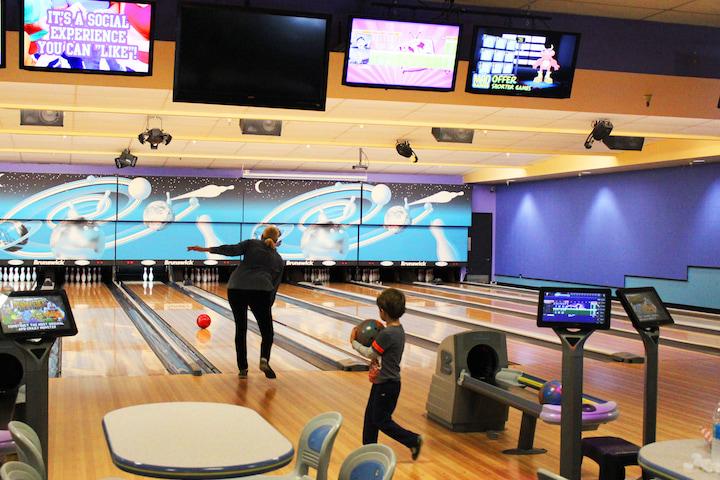 A man and boy bowling.