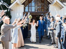 A couple exiting a venue from their wedding.