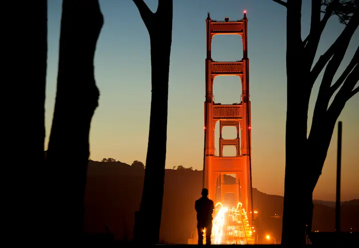 A man looks at the sunset over the Golden Gate Bridge from Golden Gate Overlook. Photo by Scott Sawyer.