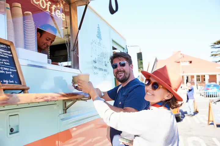 A man and a woman purchase food from a Presidio Pop Up food truck. Photo by Rachel Styer.