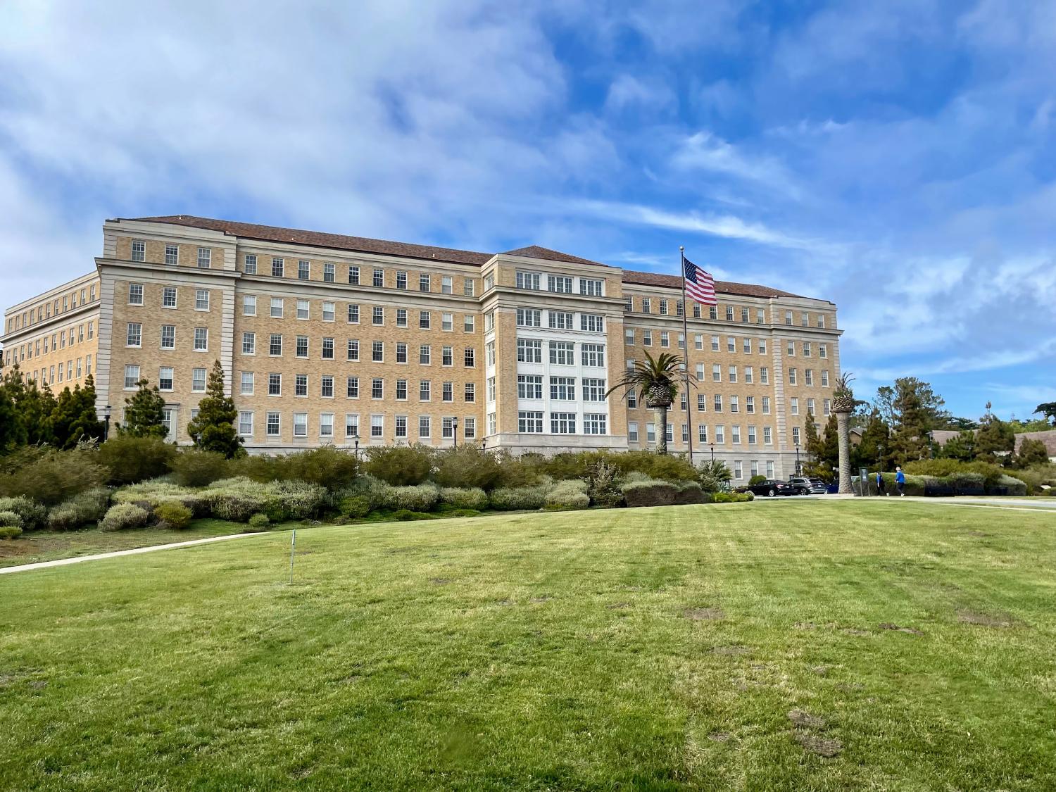 Exterior of the Presidio Landmark building, with lawn in front.