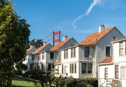 Image of houses in the Presidio with the Golden Gate Bridge in the background.