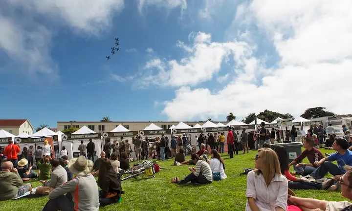 People on lawn watching planes