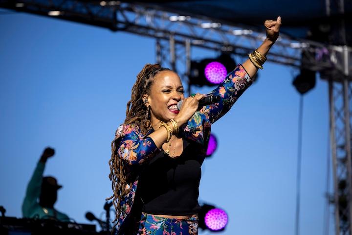 Woman performs on stage at the Environmental Justice Summit.