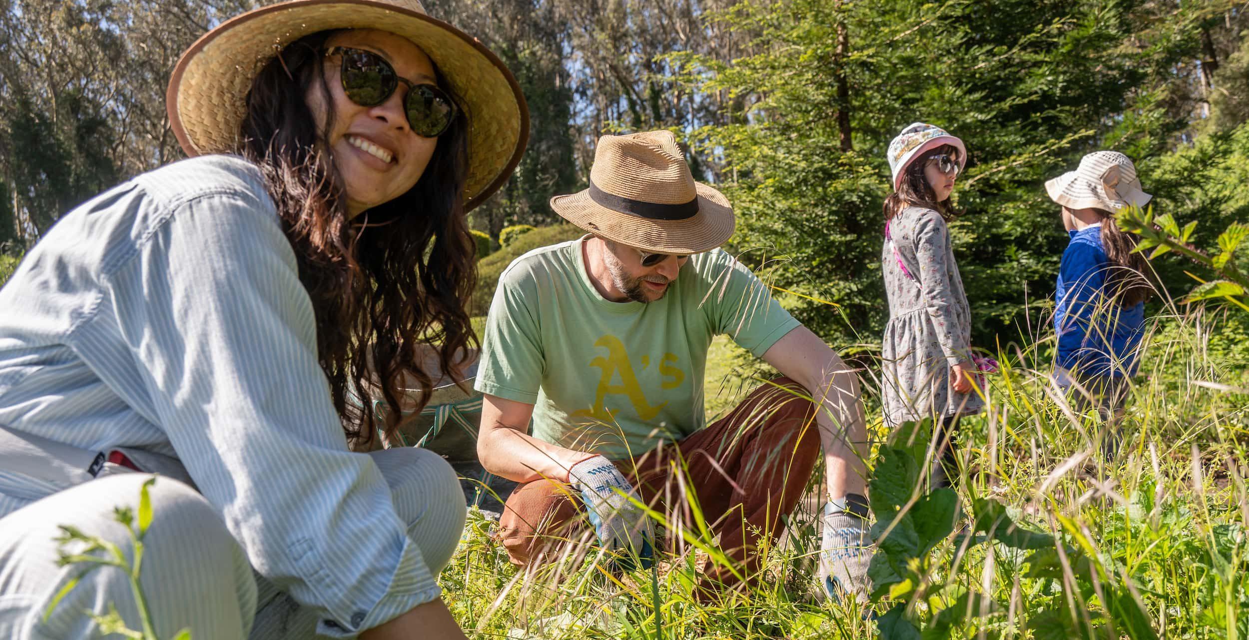 A man, woman, and two children volunteering at the Presidio. Photo by Allison Taggert-Barone.