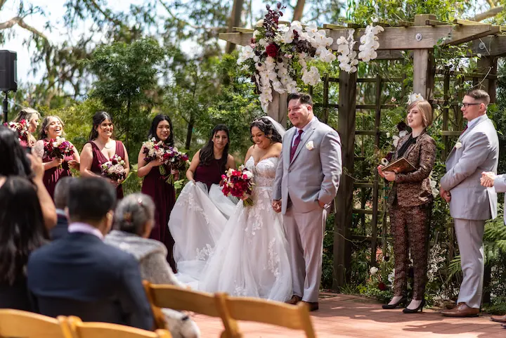 People outside at a wedding ceremony.