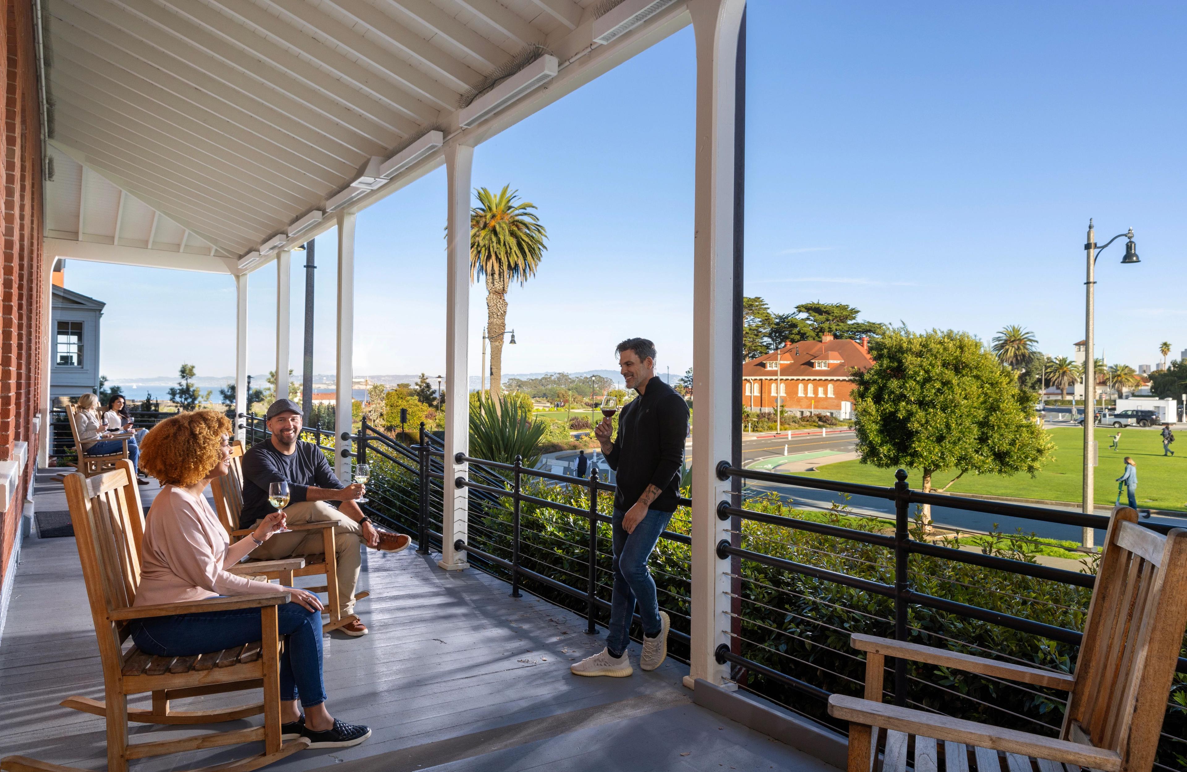 external shot of group drinking wine on Presidio Lodge porch