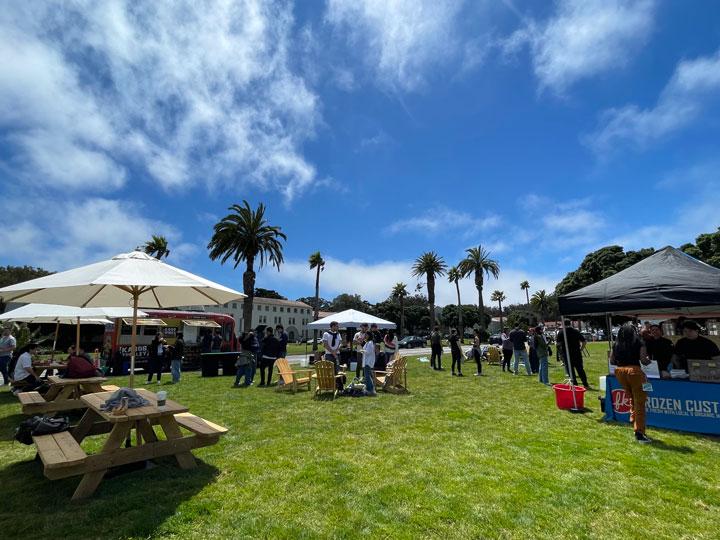 Picnic tables and chairs, food vendors, and visitors