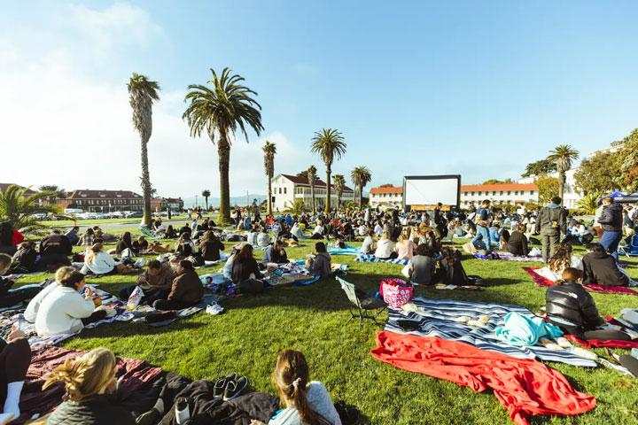 Attendees sitting on picnic blankets on Civil War Parade Lawn for Sundown Cinema