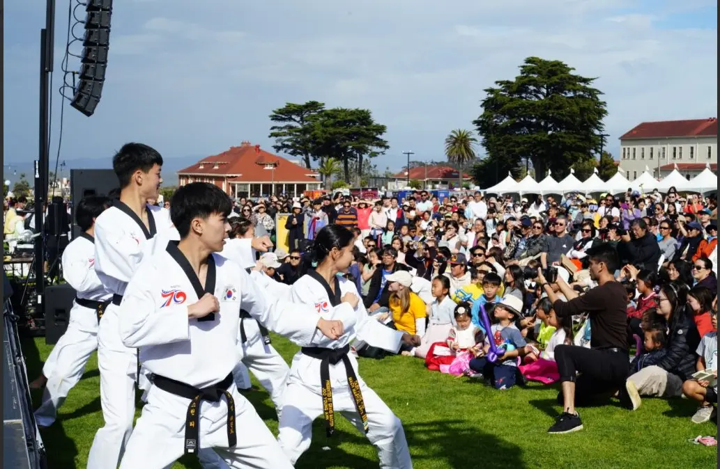 kids performing martial arts for a crowd