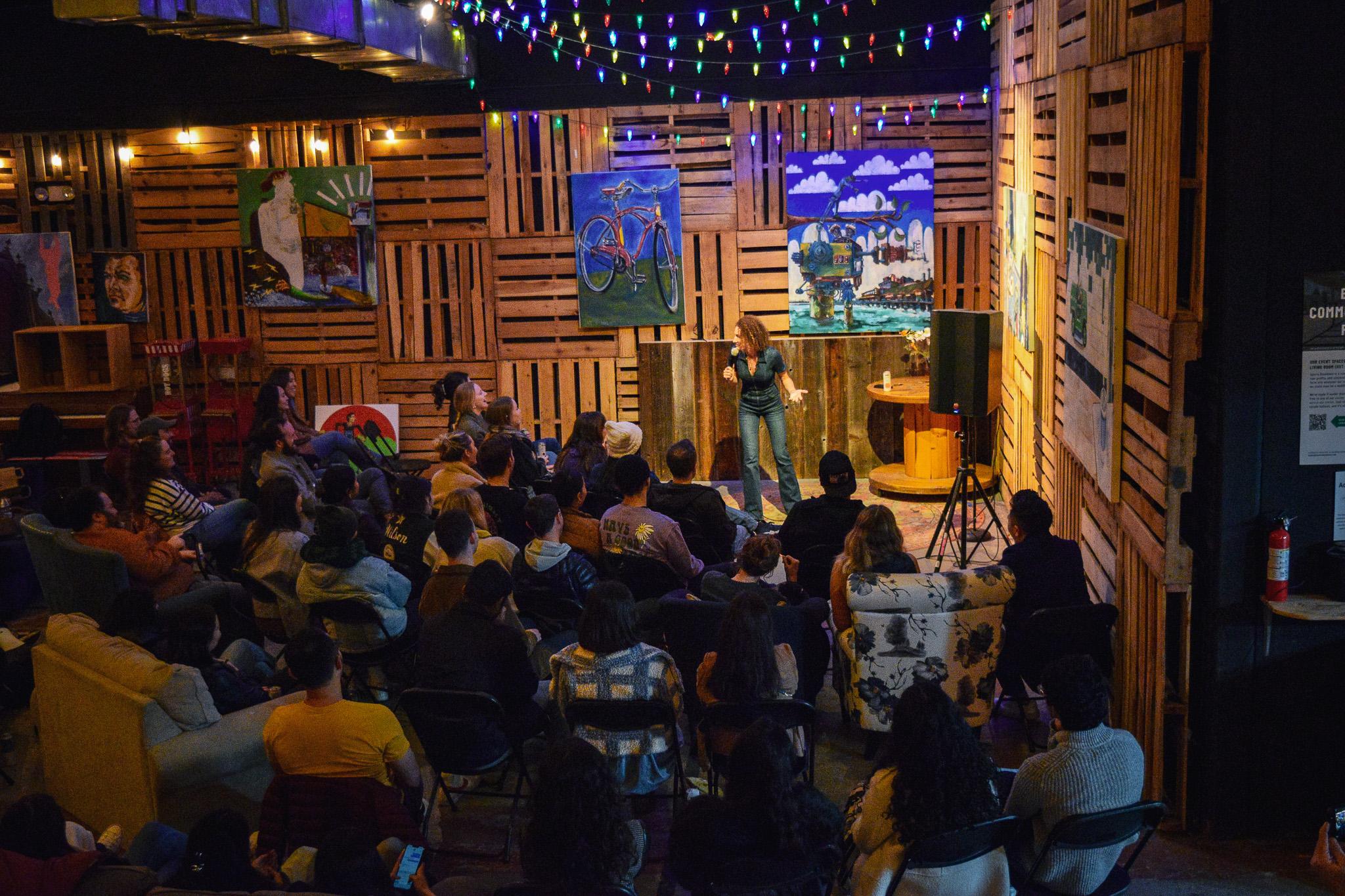 Comedian on stage with audience laughing