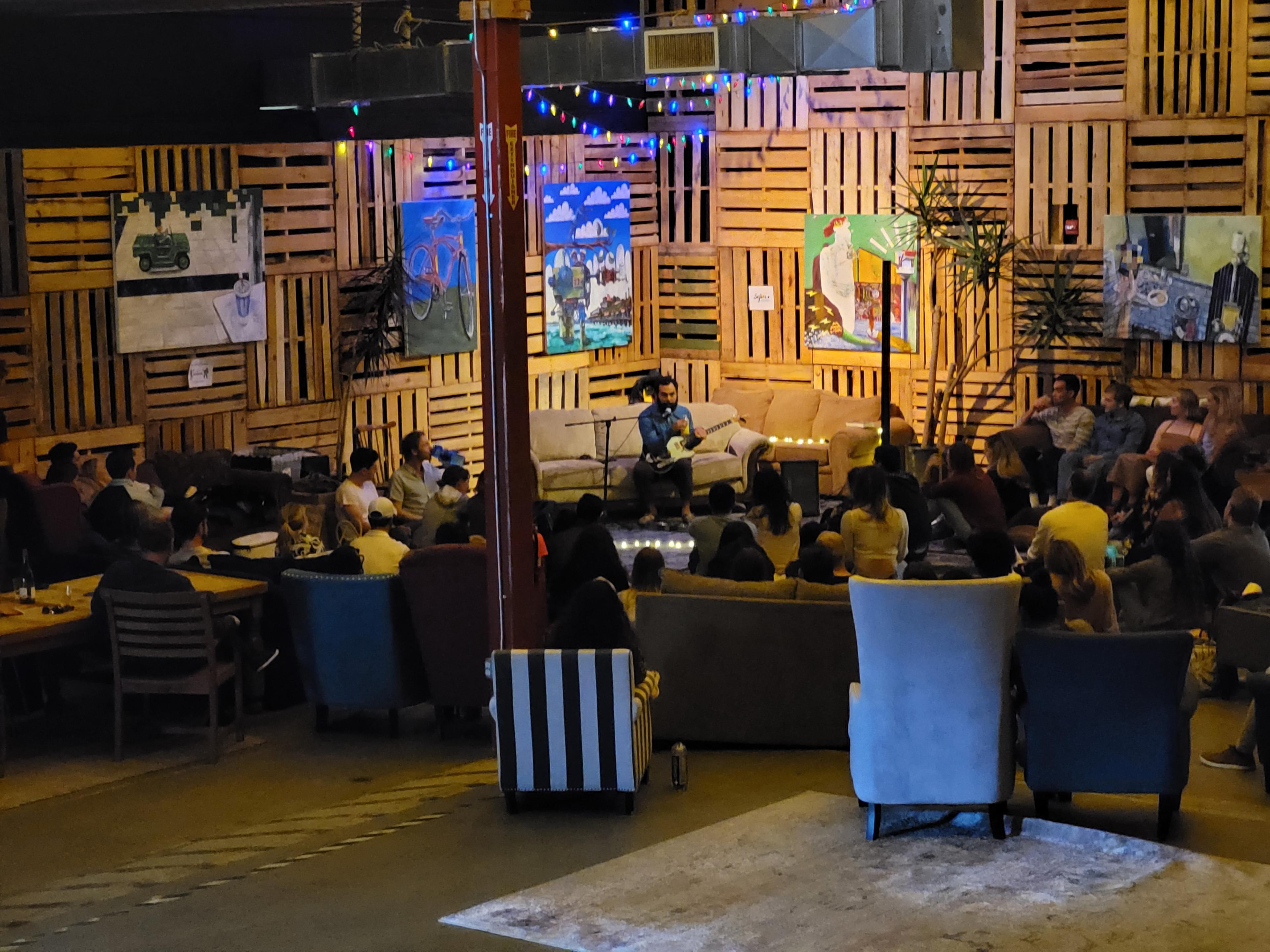 group of people sitting listening to a comedian