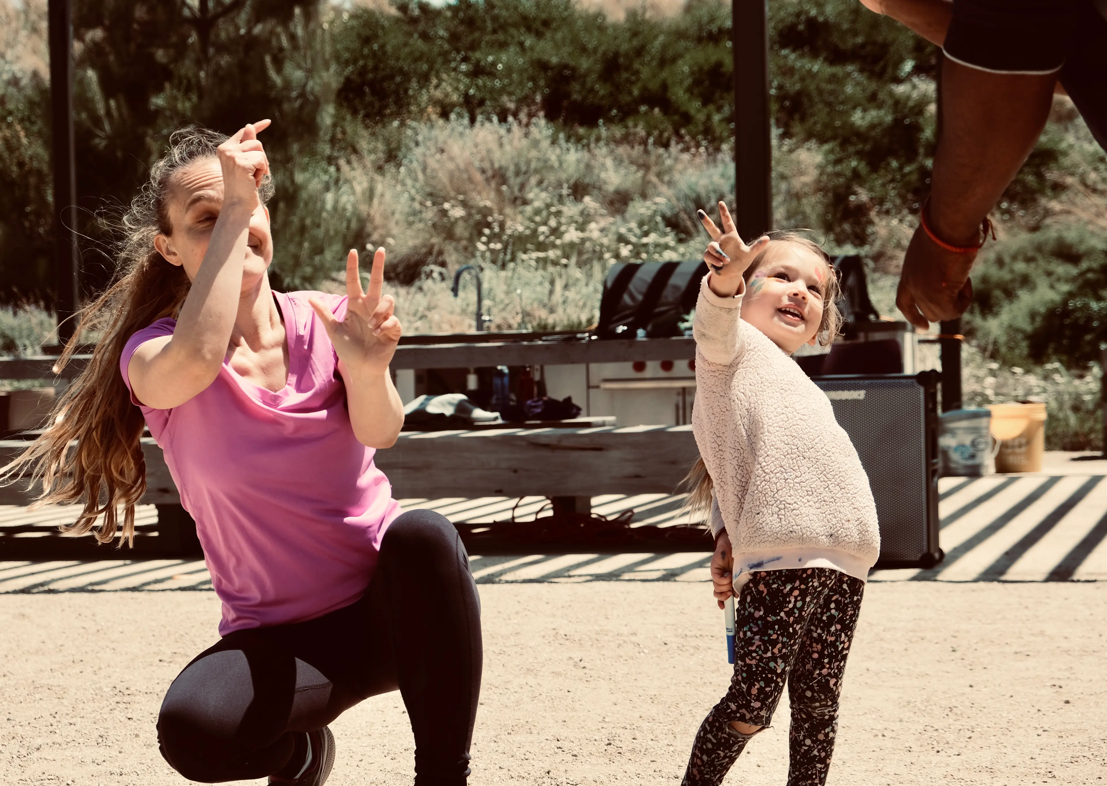 woman and child dancing together while using sign language