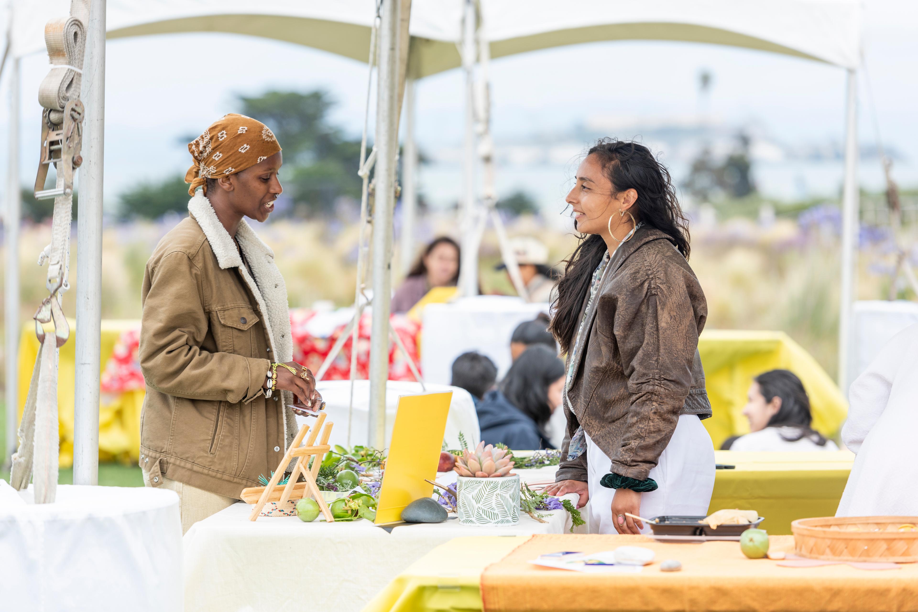 two women talking across a table