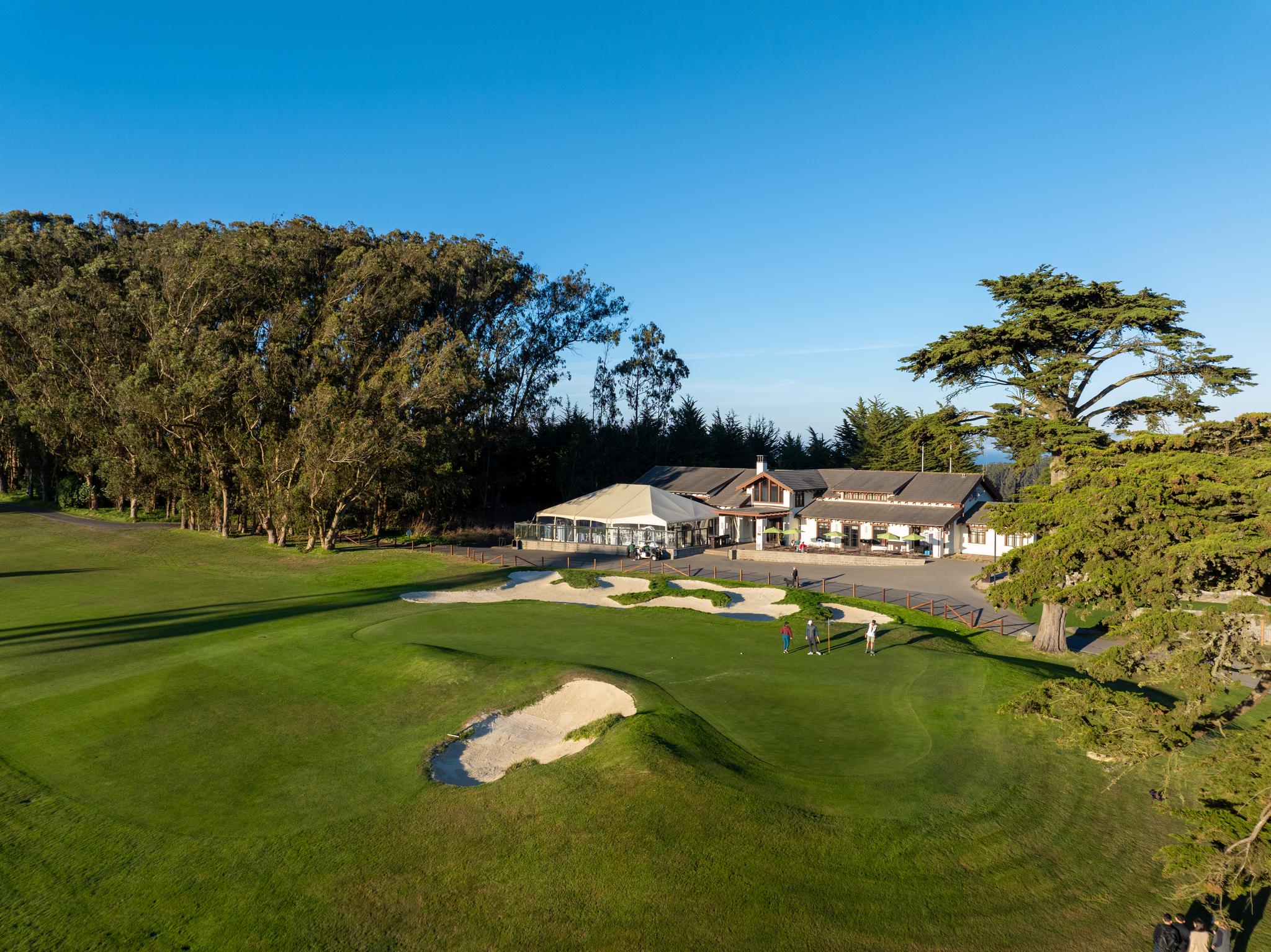 Presidio Golf Course Club House aerial from the golf course side of the building with views of the greens.