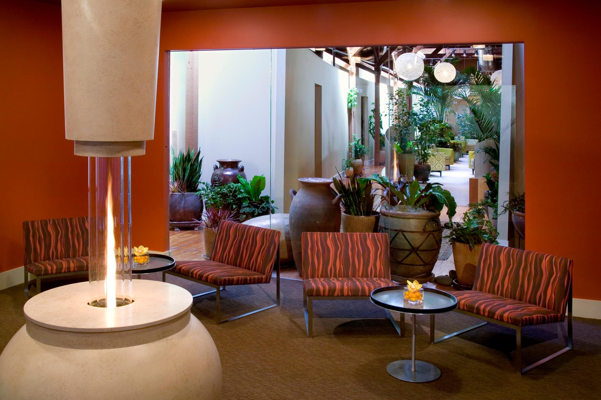 Interior of Senspa with a relaxing setting with chairs, greenery, and candles.