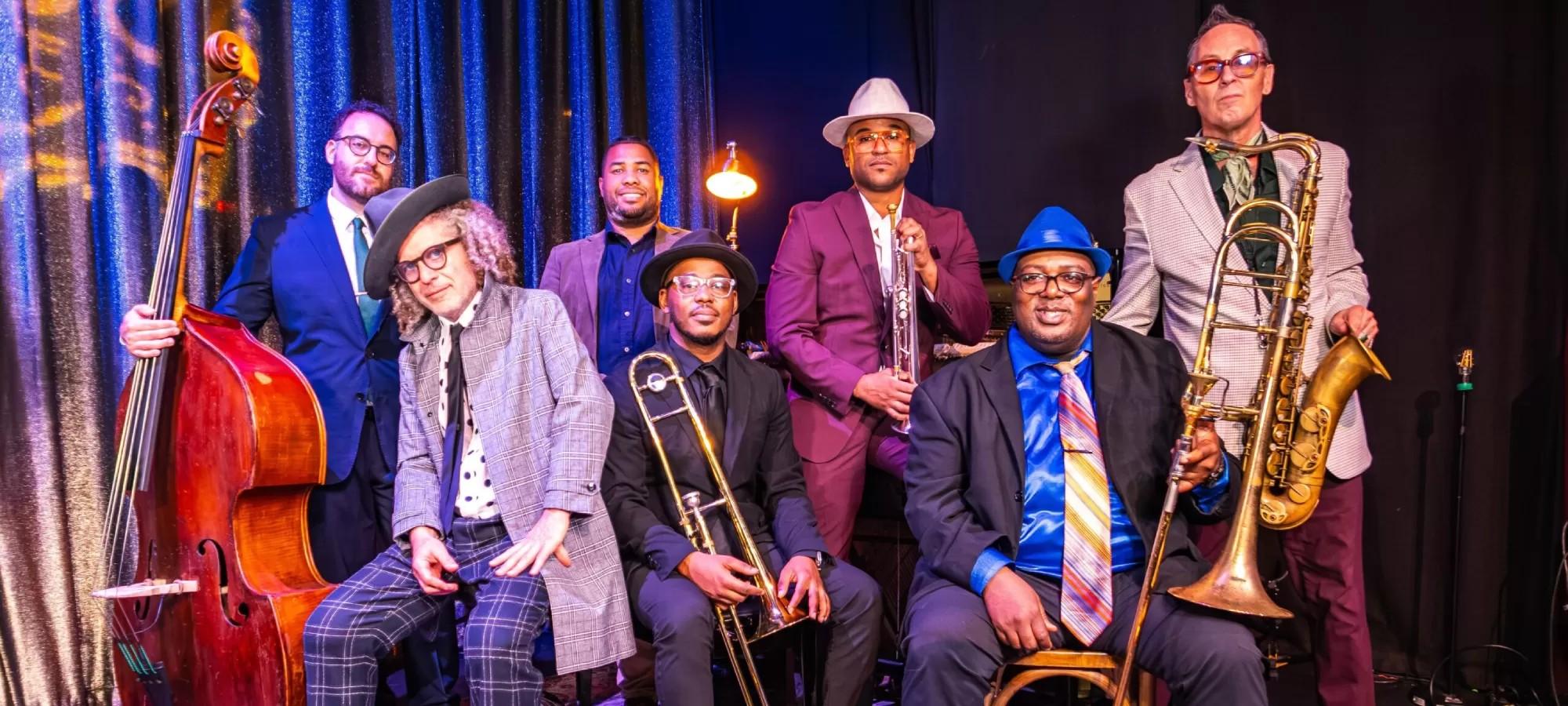 Group of musicians standing together with their instruments