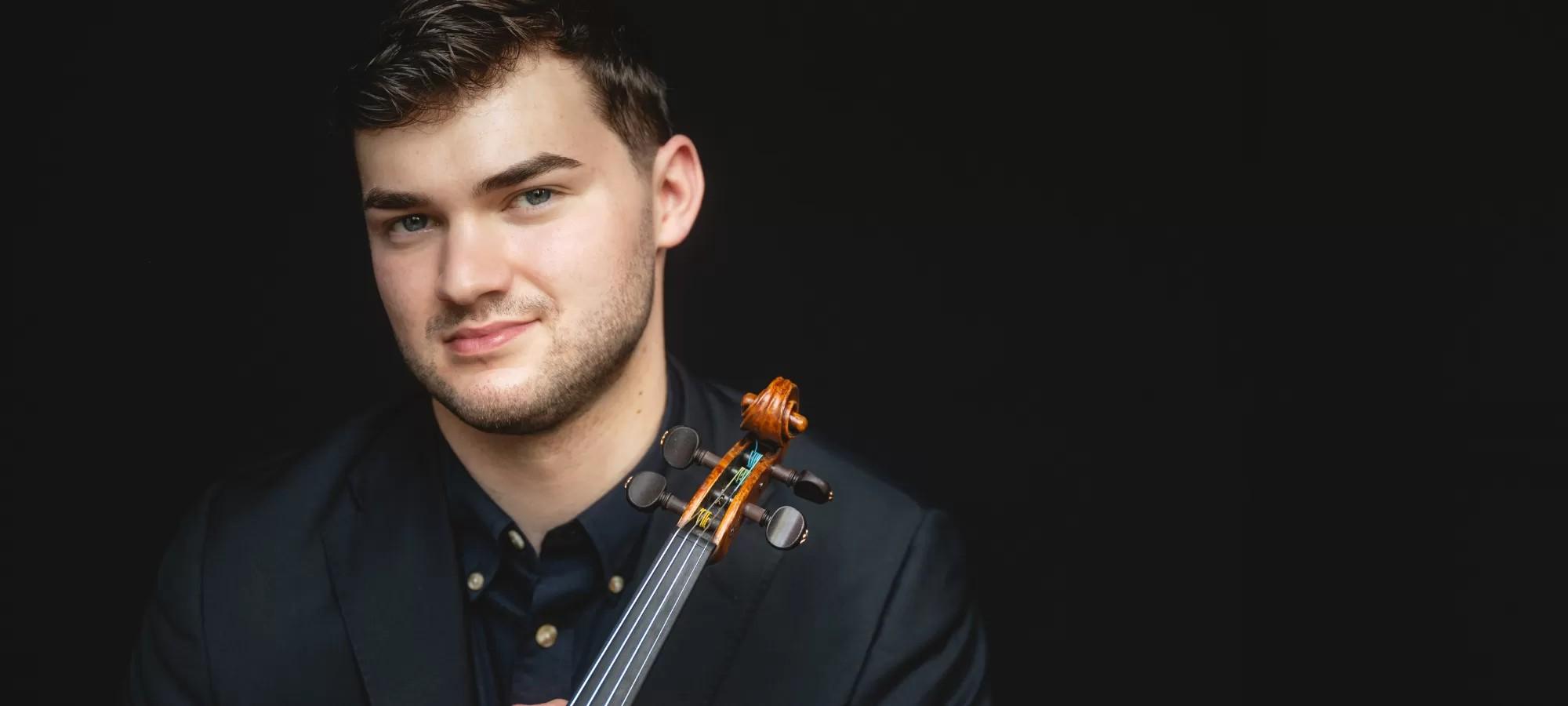 headshot of man in black tshirt