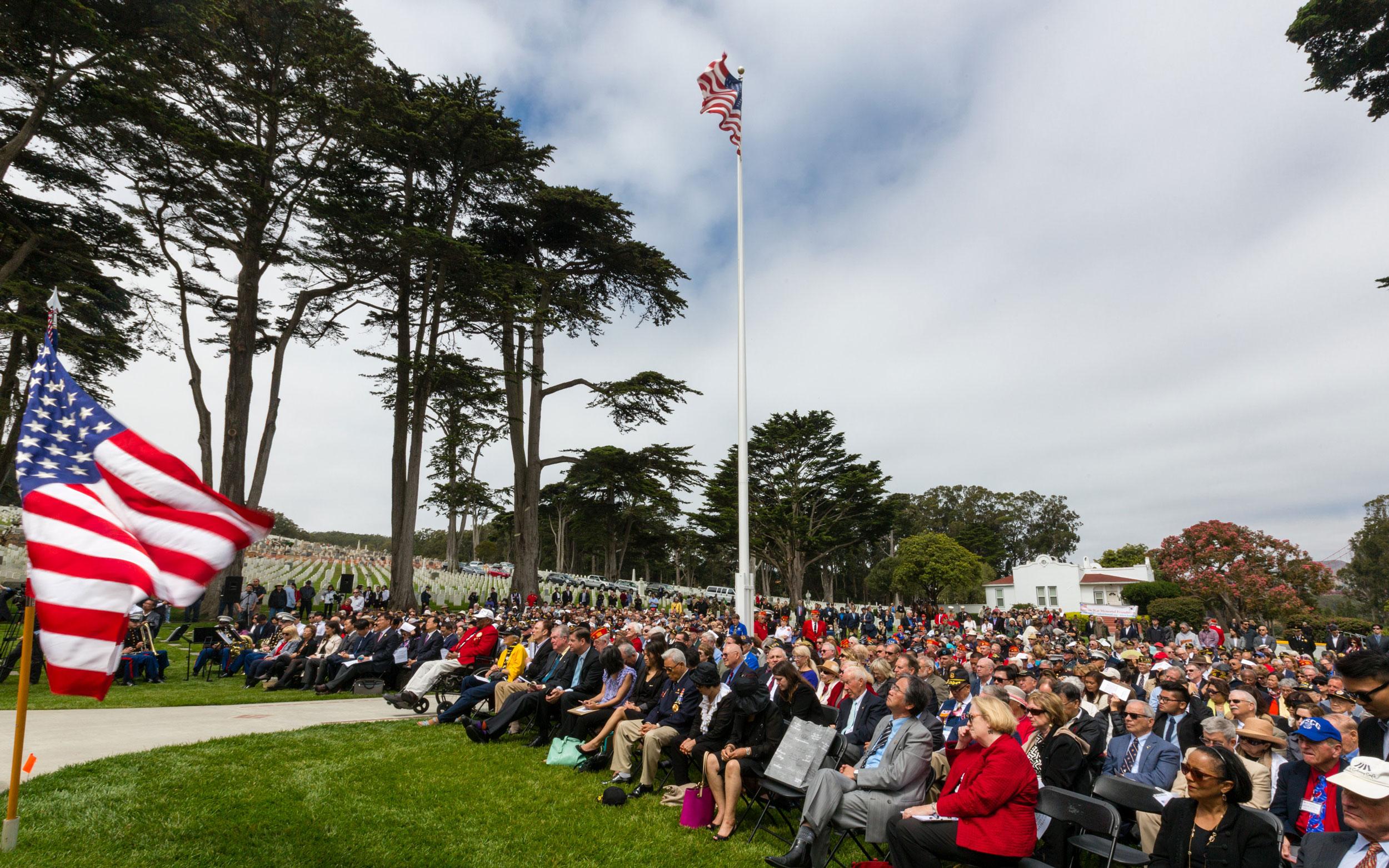 Crowd seated on lawn at San Francisco National Cemetery