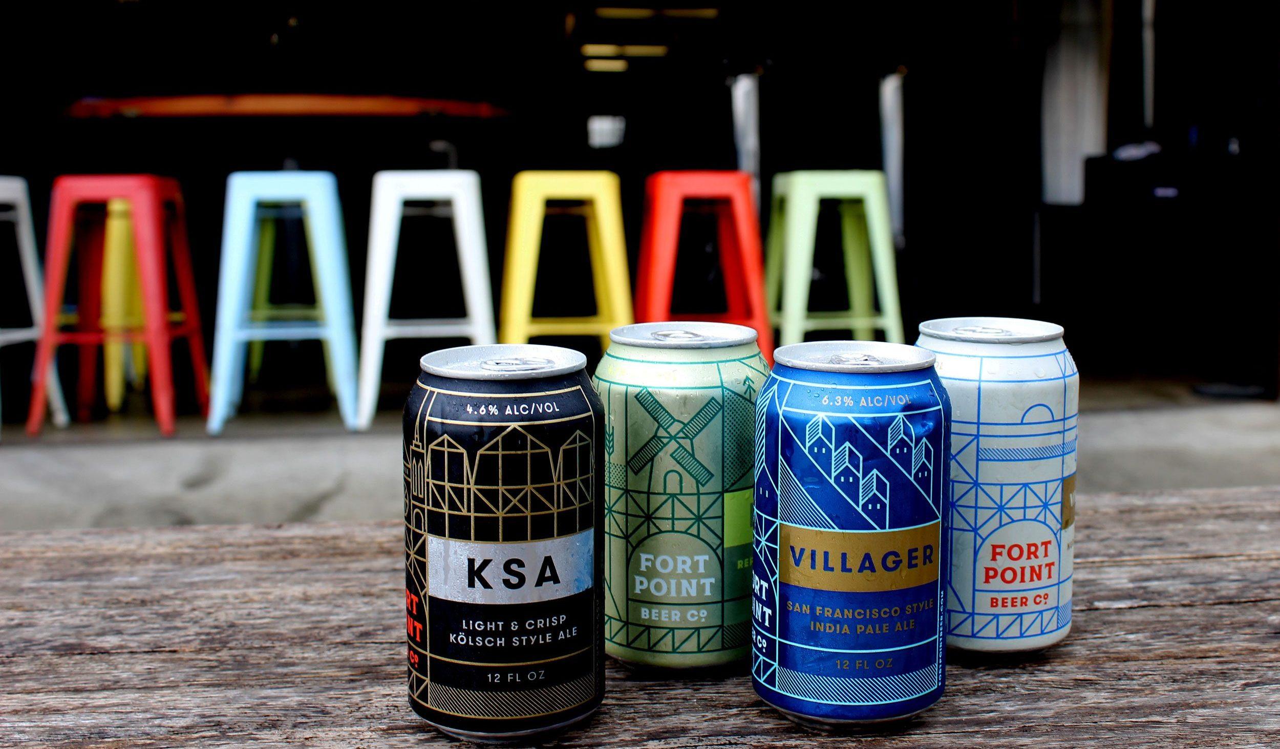 Fort Point beer cans with colorful chairs in the background