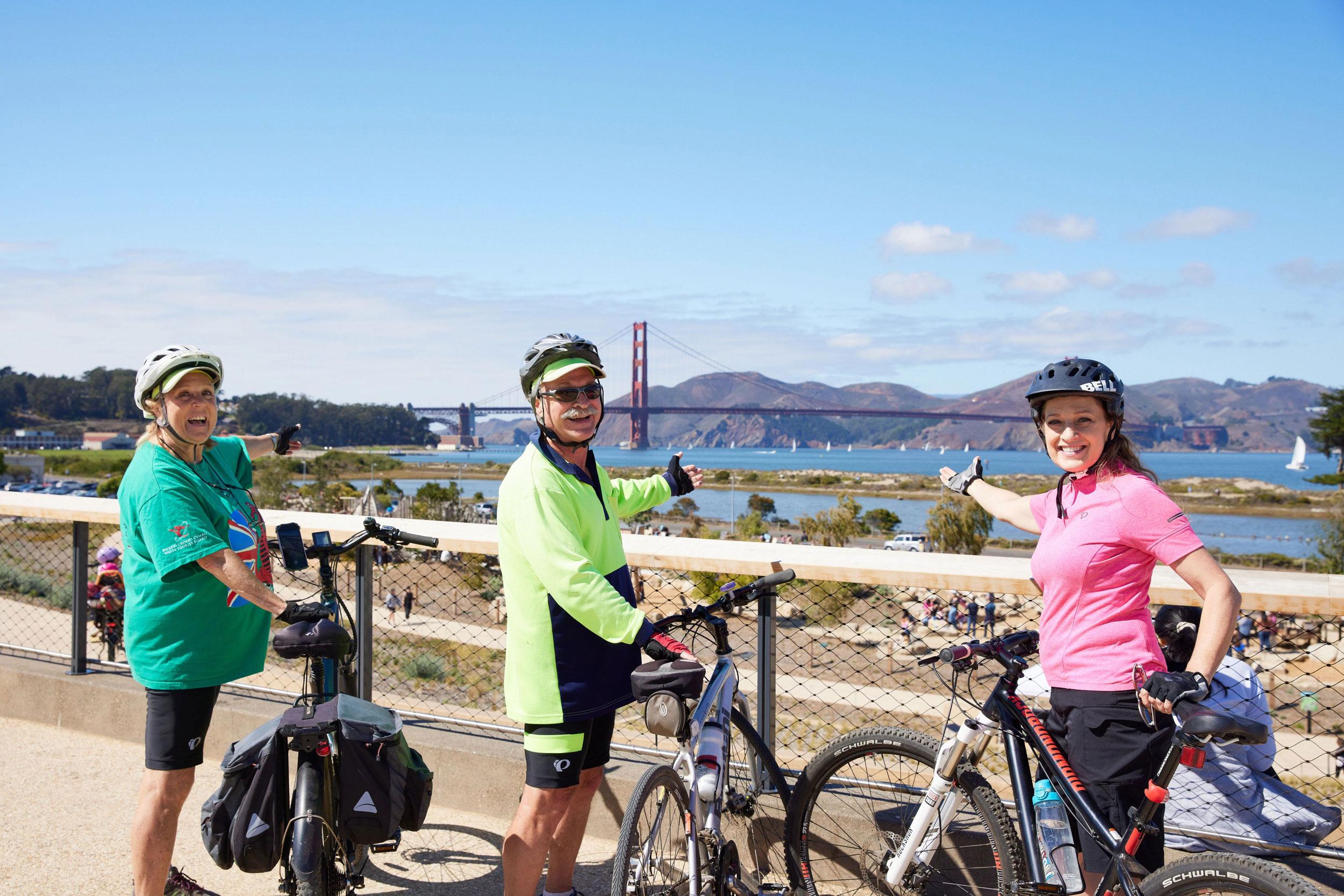 Three bicyclists in green and pink at Presidio Tunnel Tops
