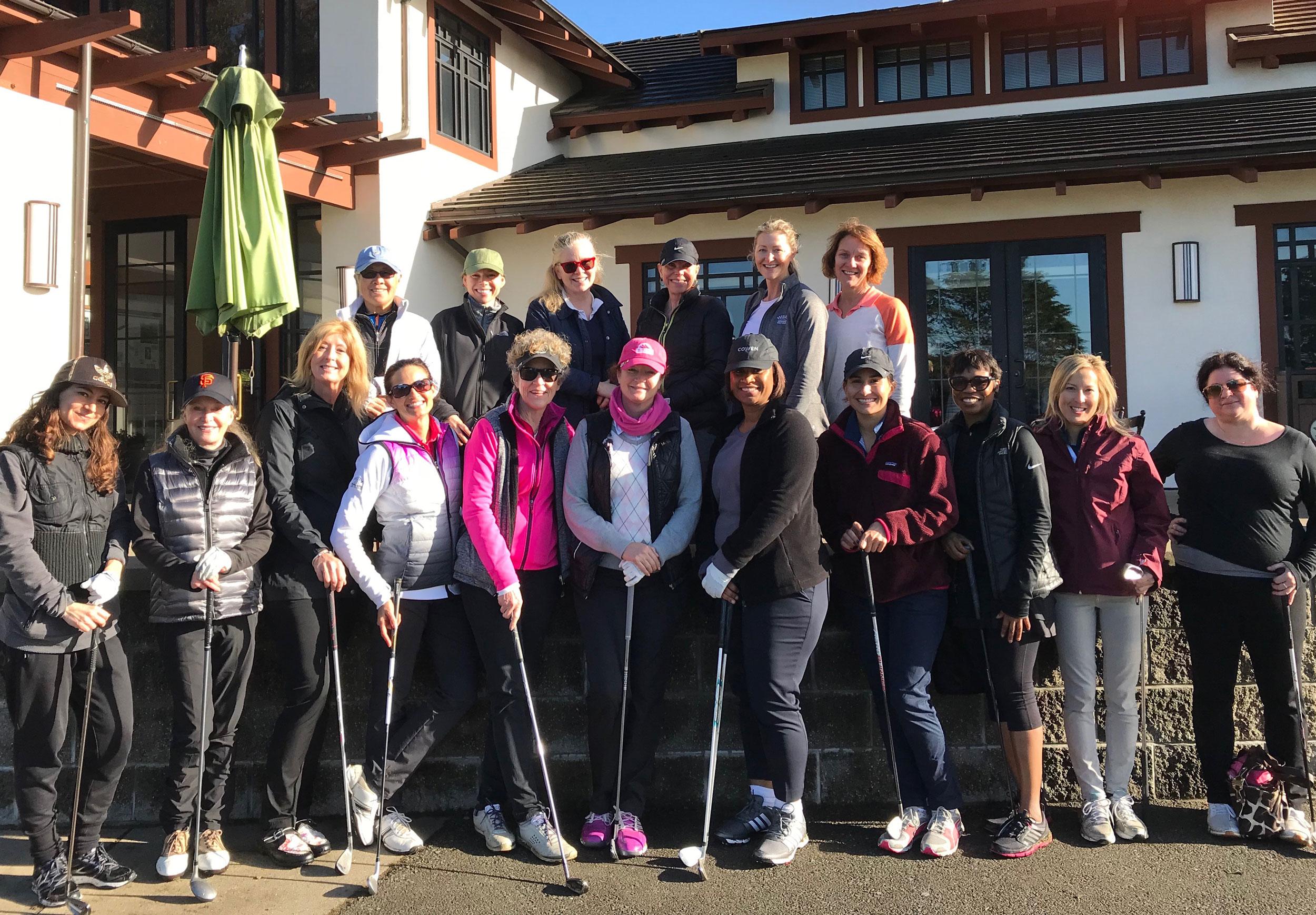 Group of female golfers pose in front of Presidio Golf Course