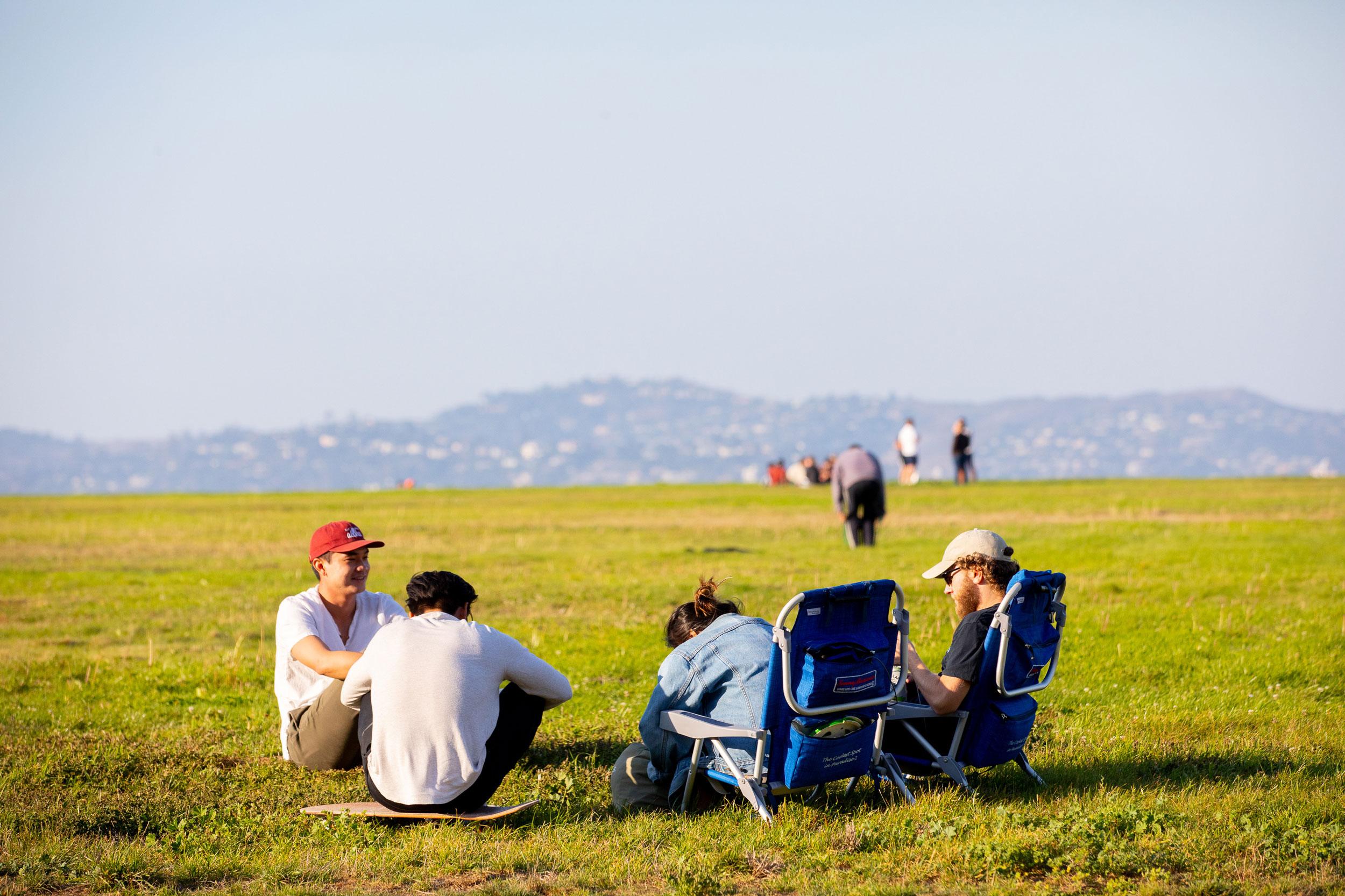 Group of picnickers seated on Crissy Field lawn