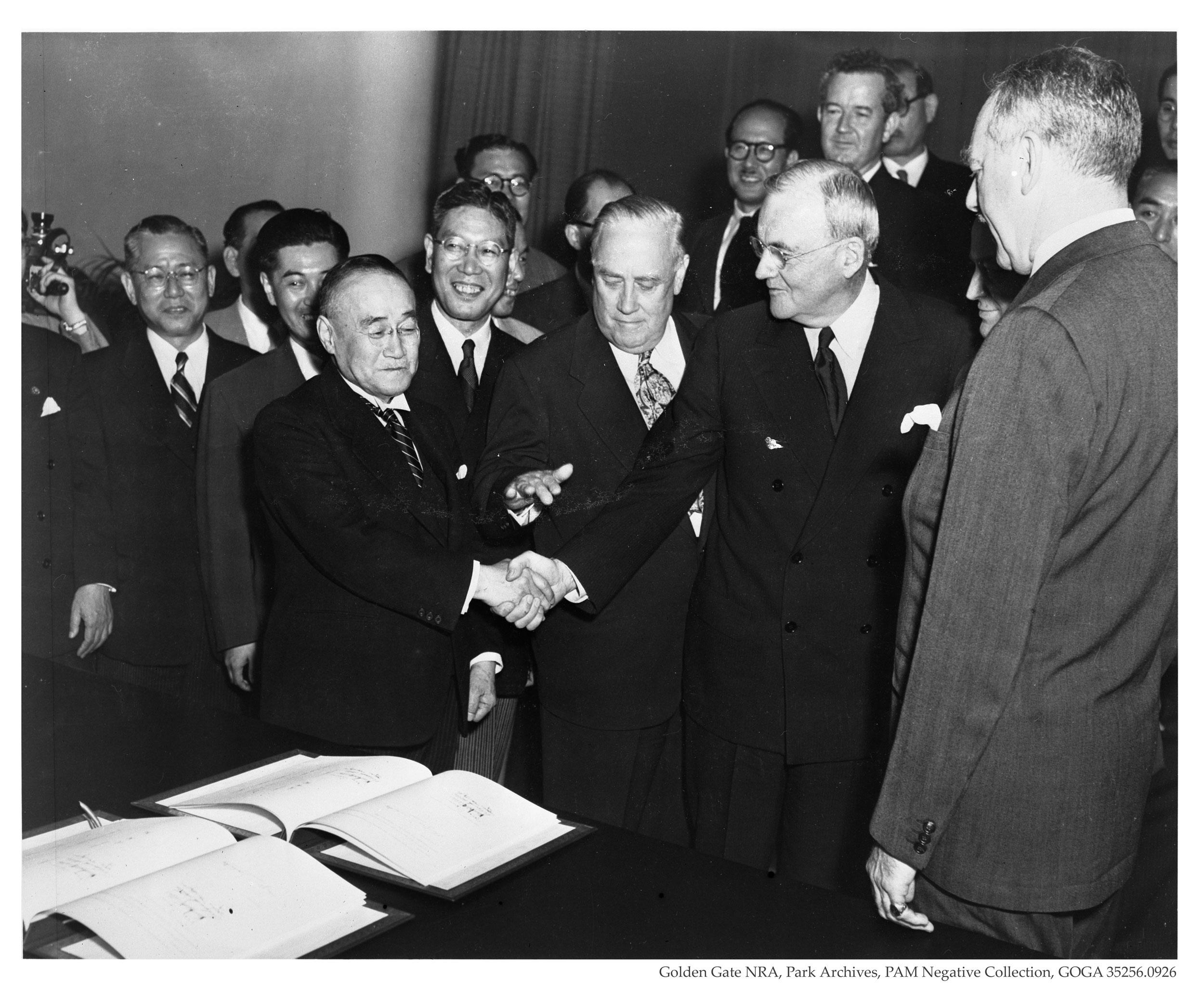 Prime Minister Shigeru Yoshida of Japan shakes hands with John Foster Dulles, chief architect of the treaty, after signing the treaty in 1951. Image courtesy GGNRA Park Archives.