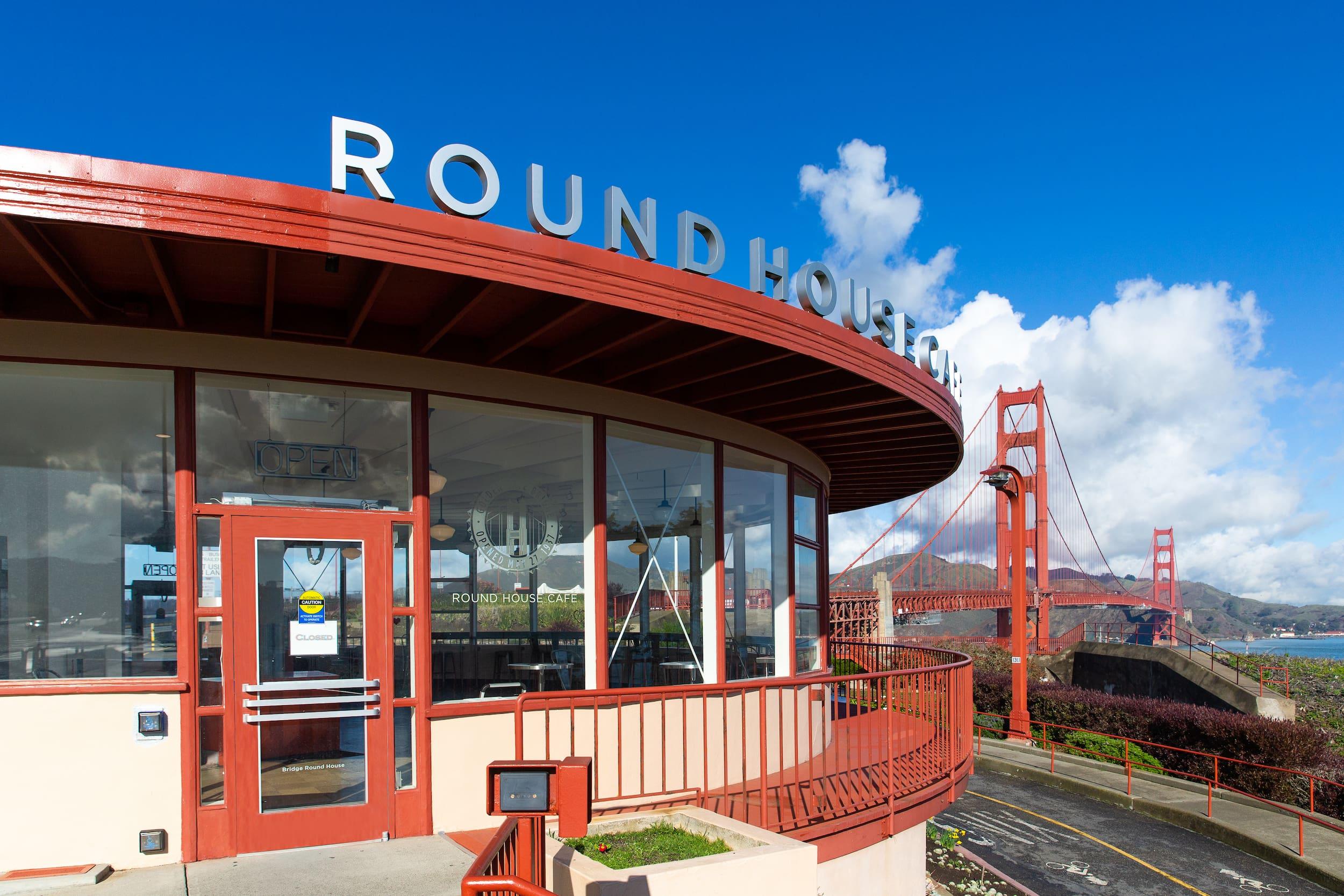 Exterior of the Round House Café in the Presidio of San Francisco, with the Golden Gate Bridge in the background. Photo by Nate Fong.