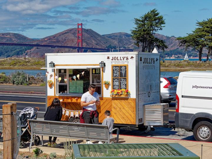 A food truck with the golden gate bridge in the background.