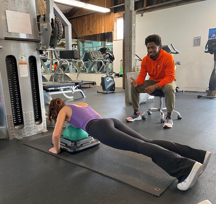 Woman doing pushups with a trainer at Presidio Sport & Medicine. Photo by Lucy Fasano.