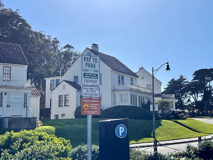 Image of a parking regulation sign in the Presidio, next to a Pay-and-Display parking machine.