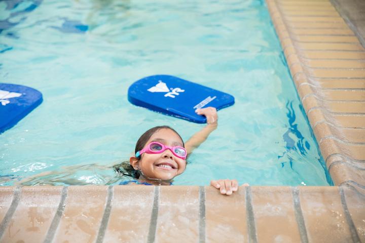 A young girl with goggles in the pool at La Petite Baleen Swim School in the Presidio. Photo courtesy of La Petite Baleen.