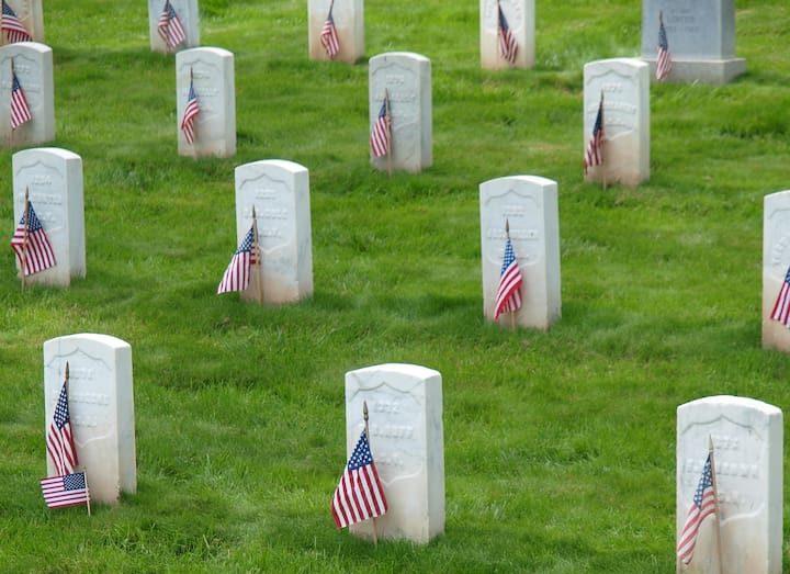 Grave markers decorated with USA flags