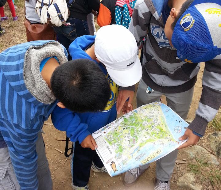Three children look at a Presidio Adventure Map.