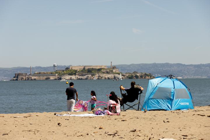 A family on the Crissy Field beach looking toward Alcatraz. Photo by Myleen Hollero.
