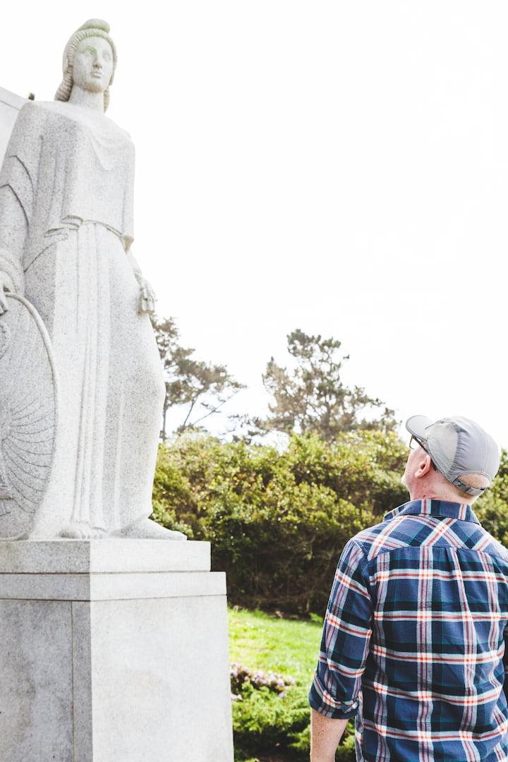 Man viewing the statue of Columbia at the World War II West Coast Memorial to the Missing in the Presidio.