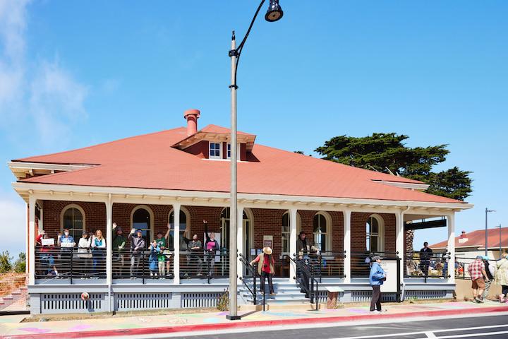Exterior of Presidio Visitor Center, with people on the porch.