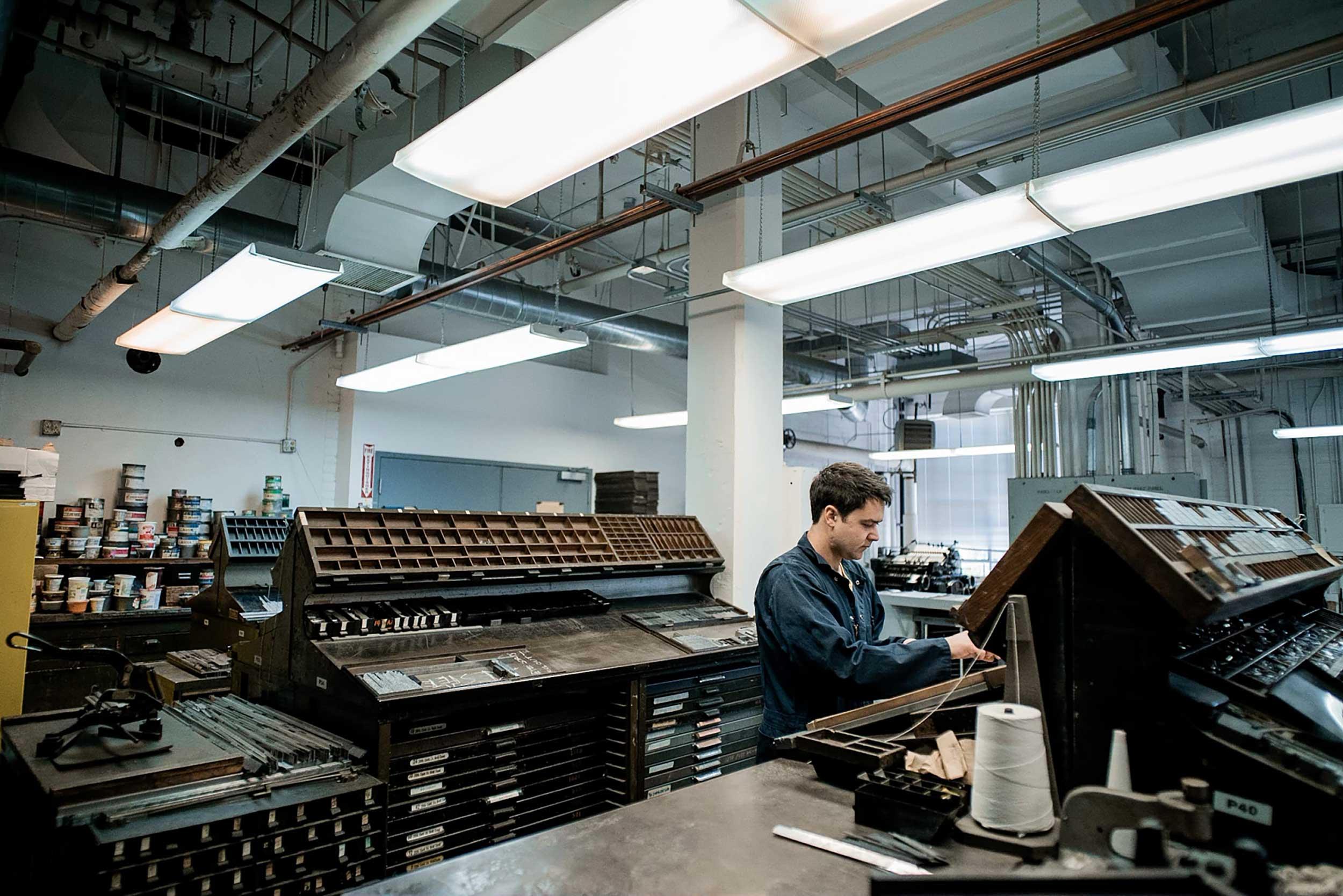 Man working to make a book at Arion Press. Photo courtesy of Arion Press.